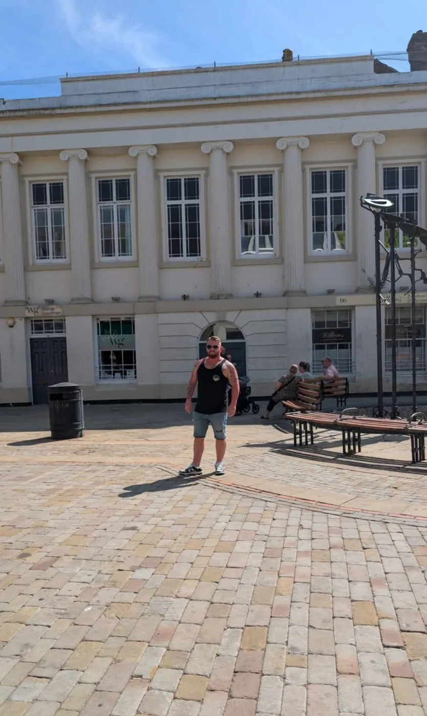 Lee Knight standing on the paved square in front of the pale stone frontage of Portland Chambers in West Street, Fareham